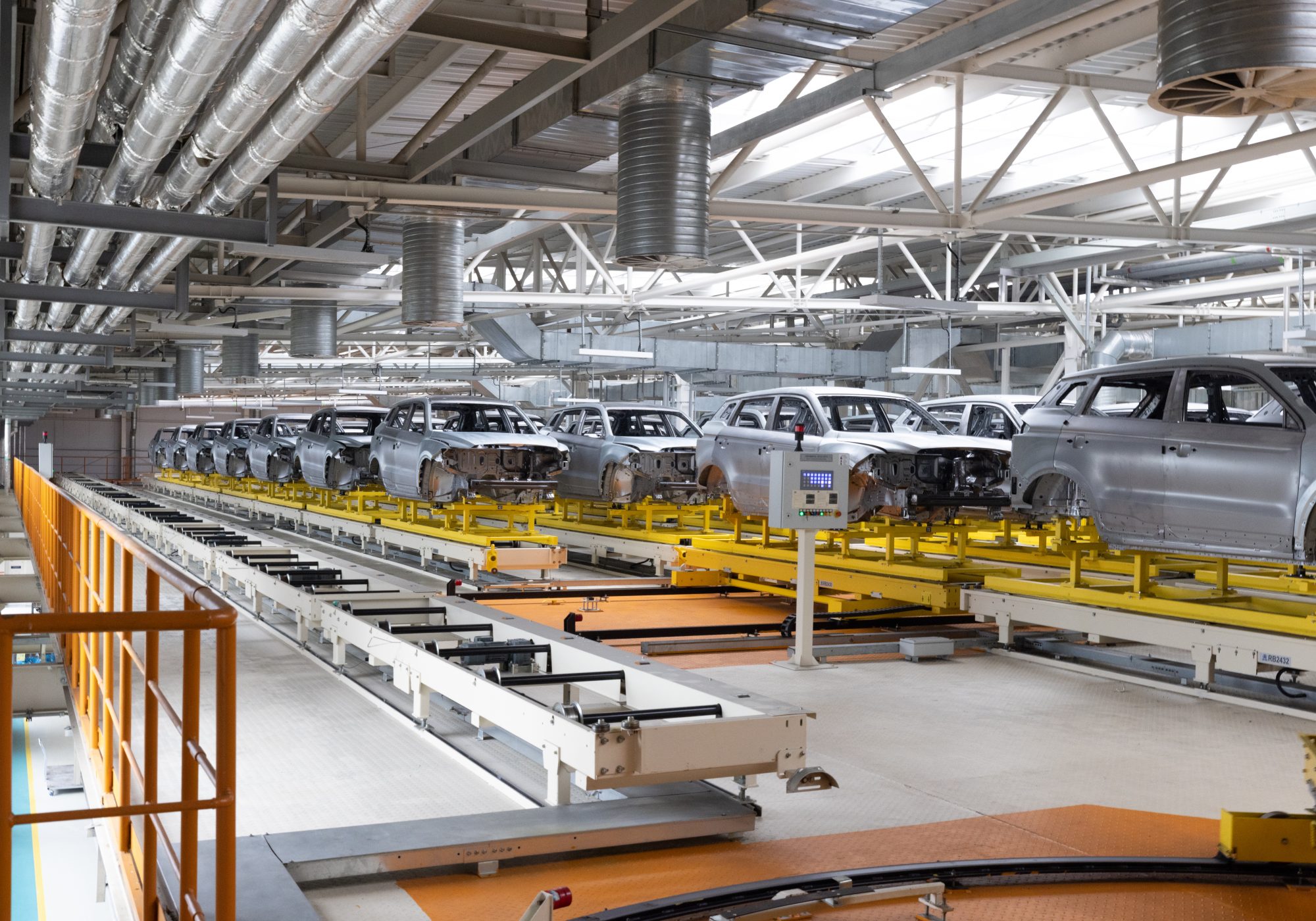 Car bodies are on assembly line. Factory for production of cars. Modern automotive industry.